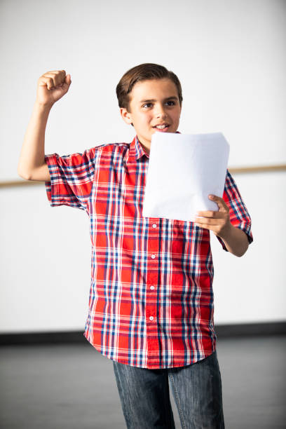 A young boy practicing his part for a drama performance